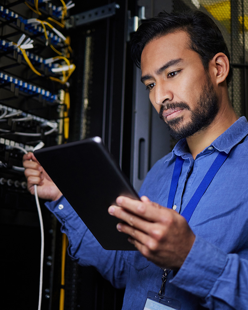 An image showing a server room or data center with a structured cabling system, where organized cables lead to network racks and switches.